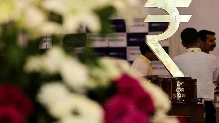 Indian rupee slips to fresh record low, intervention likely eased losses