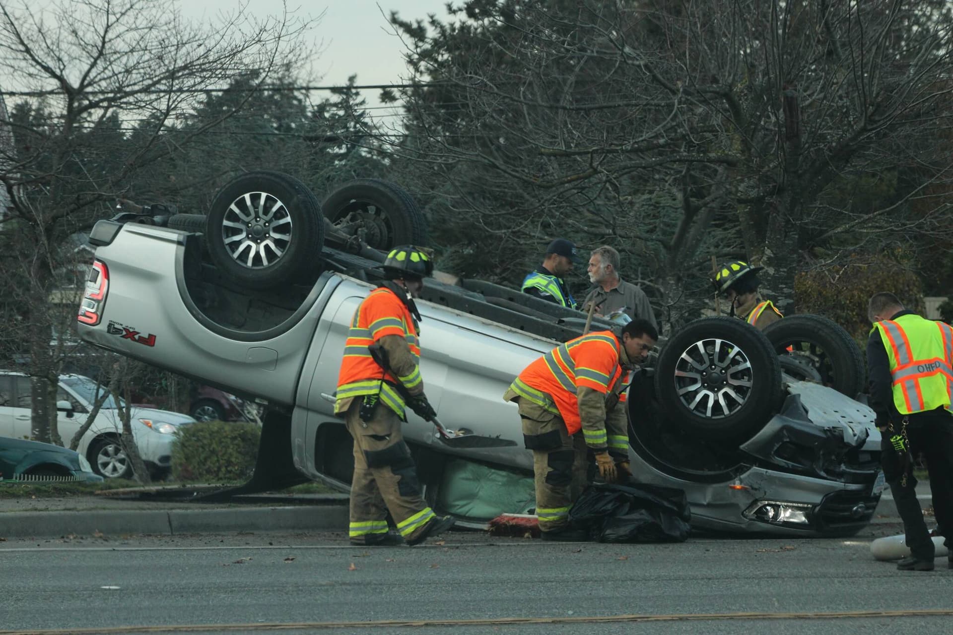 Overturned pickup, fallen light pole close Highway 20 in Oak Harbor